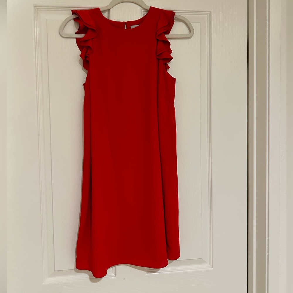 Short red polyester dress with ruffled cap sleeves.
